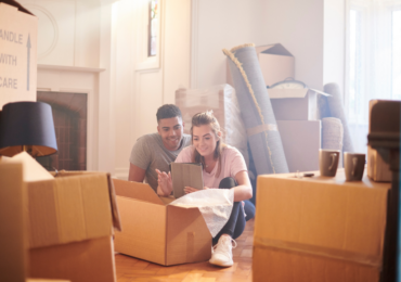 couple in new house with moving boxes