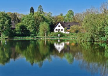 House surrounded by beautiful nature and a lake