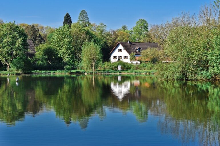 House surrounded by beautiful nature and a lake