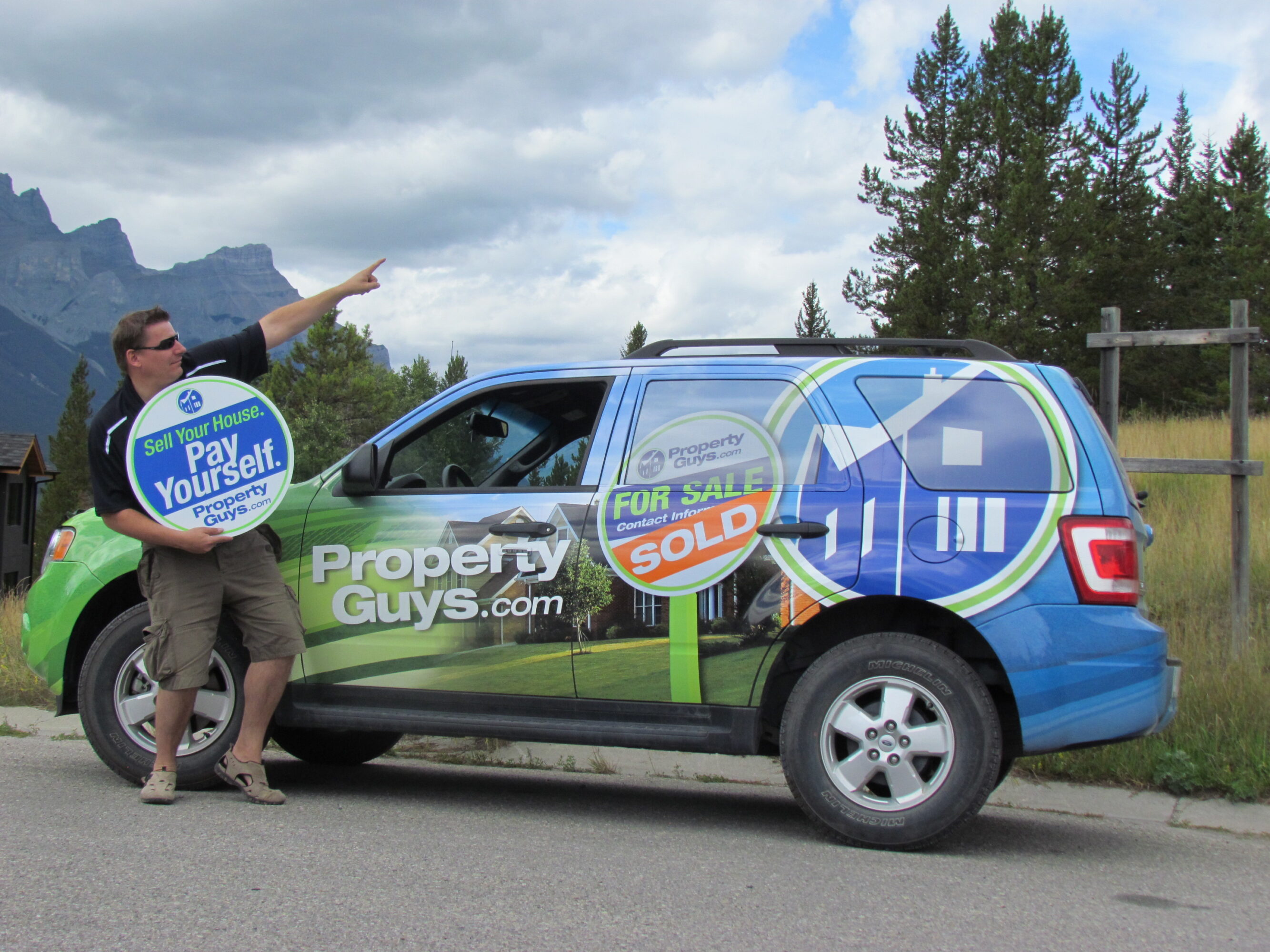 Christoph Braier with wrapped PropertyGuys.com vehicle