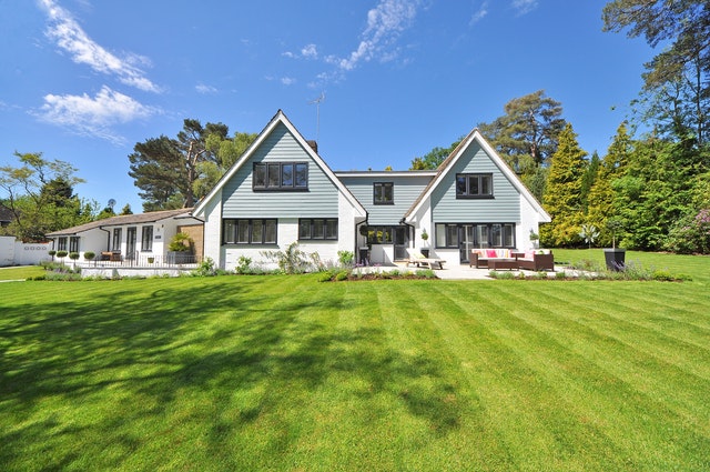 A white house with a big lawn