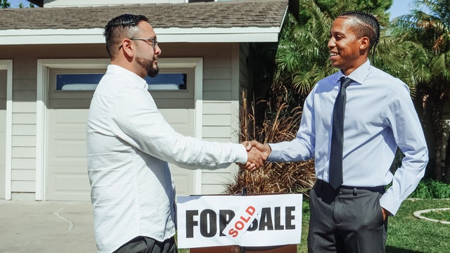 A buyer shaking hands with a seller