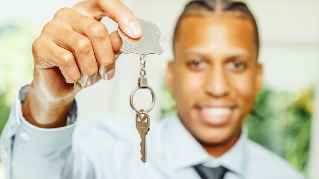 a seller handing over a key