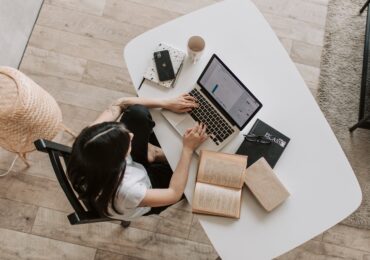 woman works on laptop at desk