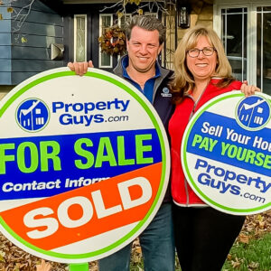 Kim and Mike Marshall with PropertyGuys.com signs