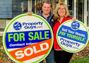 Kim and Mike Marshall with PropertyGuys.com signs