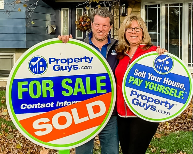 Kim and Mike Marshall with PropertyGuys.com signs