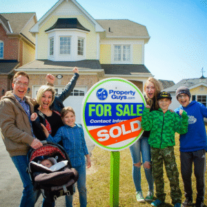 Family happily celebrating the sale of their home in front of a PropertyGuys.com “Sold” sign.