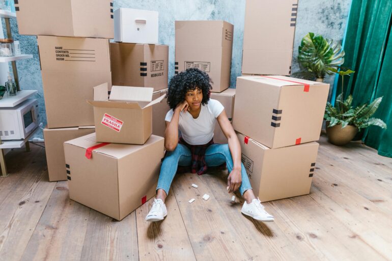a woman thinking about what to do when moving dates do not align with closing dates